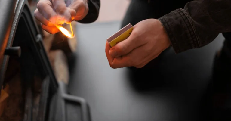 Hand striking a match
