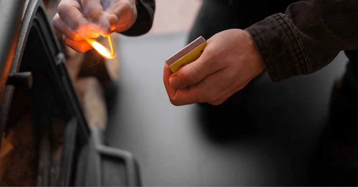 Hand striking a match